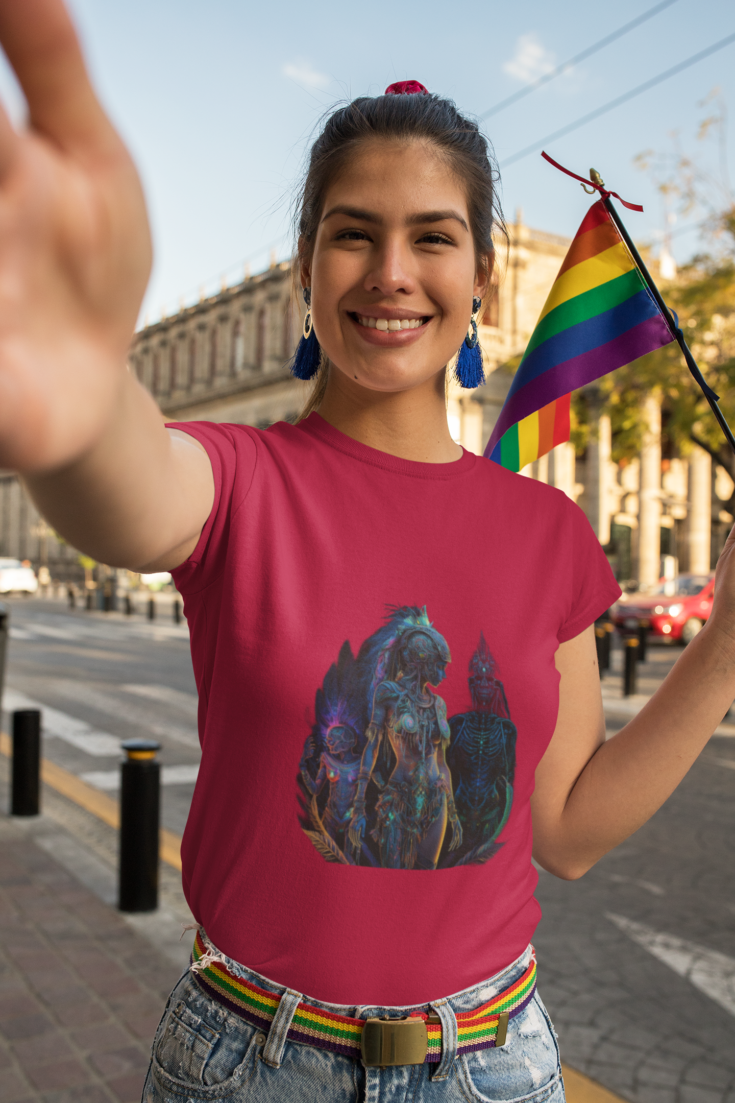 a woman with a red colour t-shirt which has a design of a surreal and intricate depiction of an amazon warrior princess holding a rainbow flag