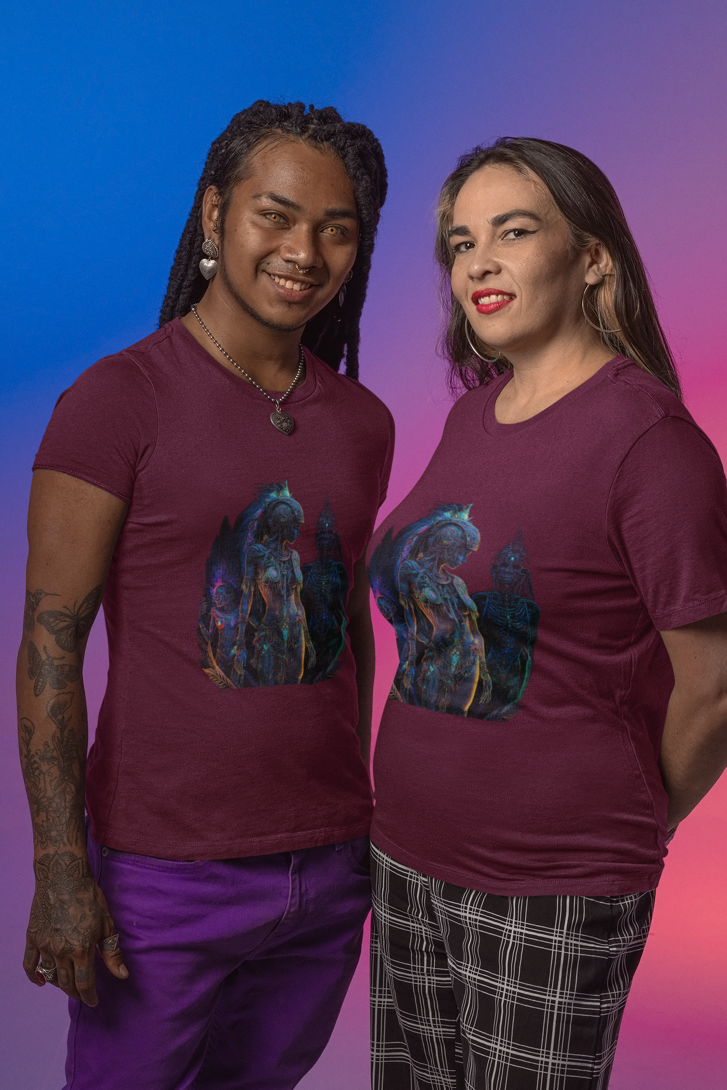 maroon colour t-shirt which has a design of a surreal and intricate depiction of an amazon warrior princess worn by a happy male and a female posing against a colourful background