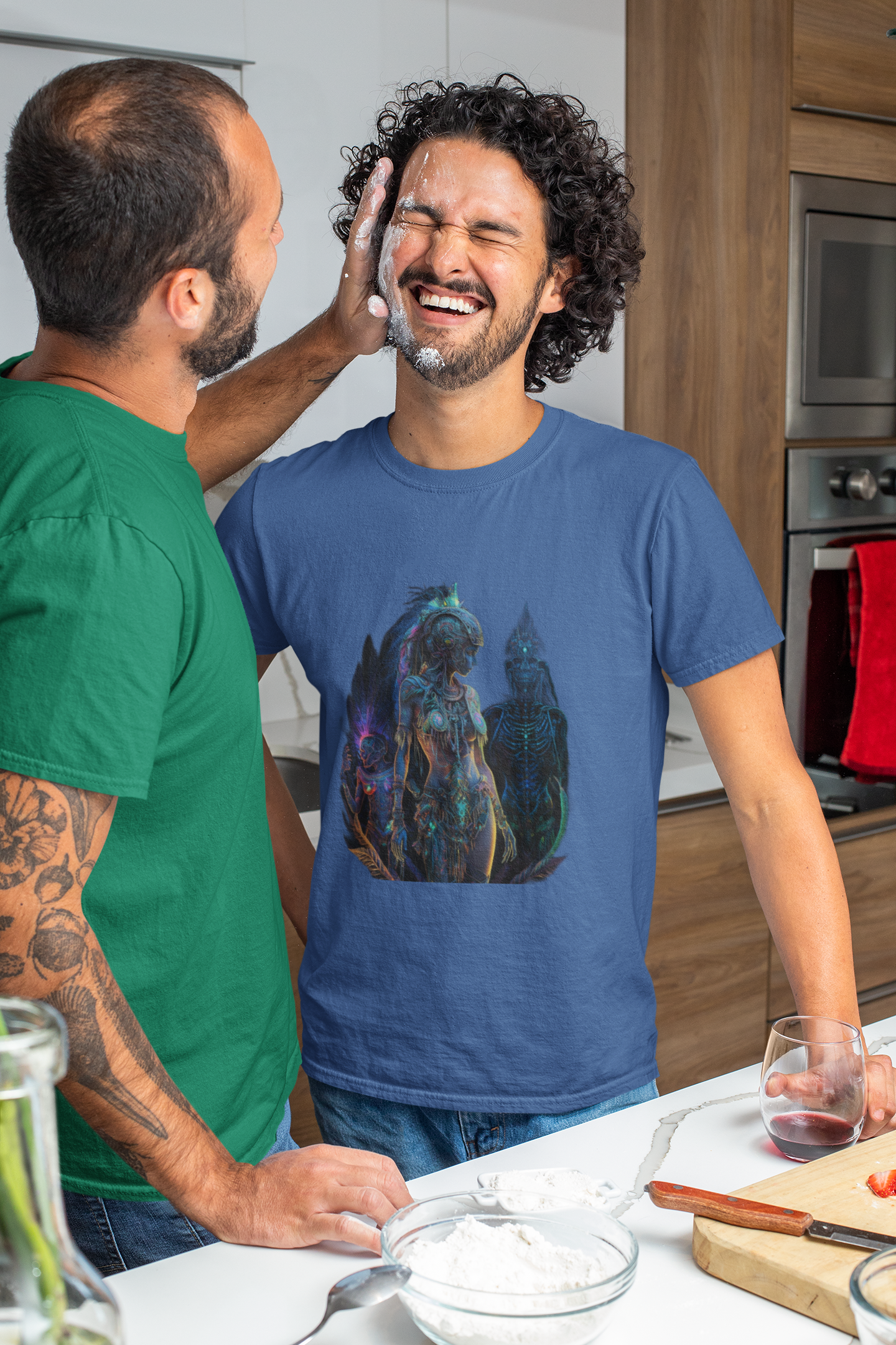royal blue colour t-shirt which has a design of a surreal and intricate depiction of an amazon warrior princess worn by an lgbt couple having fun while cooking
